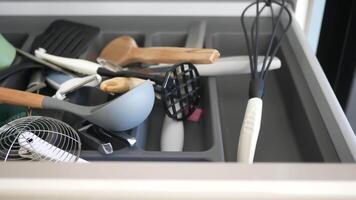 Close up of messy kitchen utensil drawer. video