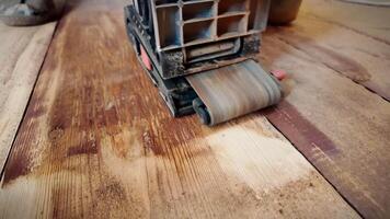 Sanding a floor with a grinding machine close-up . video