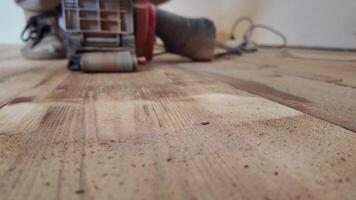 Modern renovation, Sanding a floor with a grinding machine close-up . video