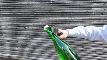 persoon Holding en opening fles van wijn. Champagne saberen. video