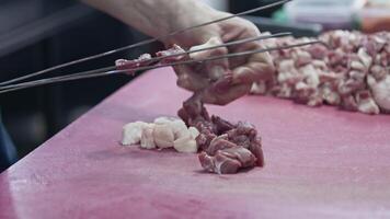 Shish Kebab Master Strings Lamb Meat on Skewers and Prepares It for Barbeque Fire Footage. video