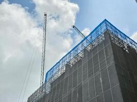 construction site tall building against sky in city photo