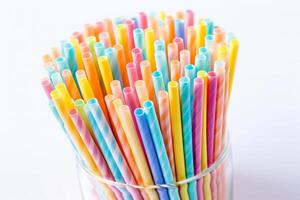 Colorful drinking straws in container. photo