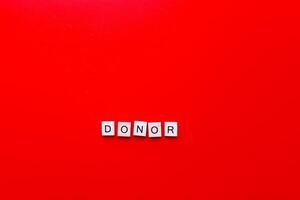 Blood donor on a red background. Volunteering. Help people. Medicine photo