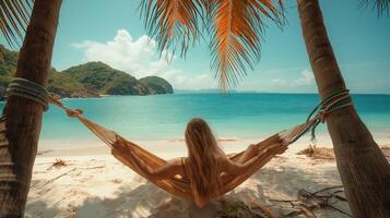 Beautiful beach. Hammock between two palm trees on the beach. Holiday and vacation concept photo