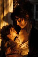 A woman and a little girl ,holding and playing with her daughter , Mother's day photo