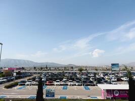 Afines, Greece - 20 august 2023. Huge parking lot with parked cars against the backdrop of a mountain range photo