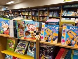 Herceg-Novi, Montenegro - 17 august 2023. Colorful educational picture books and comics stand on the shelves in a bookstore photo