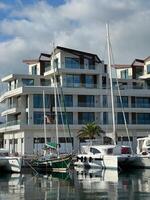 Herceg-Novi, Montenegro - 17 august 2023. Sailing yachts are moored near the hotel on the seashore photo