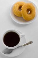 Cup of Tea and Doughnuts for Eating on Relaxing Time photo