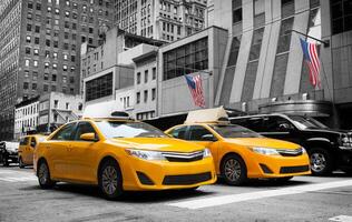 Classic street view of yellow cabs in New York city photo