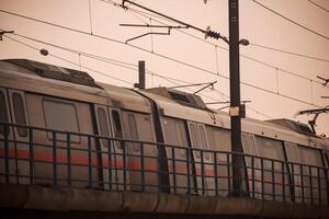 New Delhi, India, February 17 2024 - Delhi Metro train arriving at Jhandewalan metro station in New Delhi, India, Asia, Public Metro departing from Jhandewalan station photo