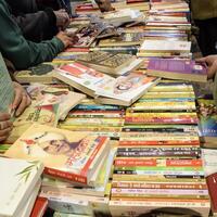 New Delhi, India, February 17 2024 - Variety of Books on shelf inside a book-stall at Delhi International Book Fair, Selection of books on display in Annual Book Fair at Bharat Mandapam complex photo