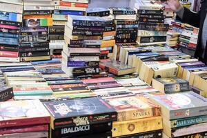 New Delhi, India, February 17 2024 - Variety of Books on shelf inside a book-stall at Delhi International Book Fair, Selection of books on display in Annual Book Fair at Bharat Mandapam complex photo