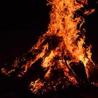 Fire flames on black background, Blaze fire flame texture background, Beautifully, the fire is burning, Fire flames with wood and cow dung bonfire photo