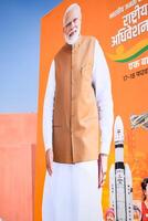 New Delhi, India - February 17 2024 - Prime Minister Narendra Modi cut out during BJP road show, the poster of PM Modi while attending a big election rally in the capital photo