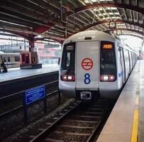 New Delhi, India, February 17 2024 - Delhi Metro train arriving at Jhandewalan metro station in New Delhi, India, Asia, Public Metro departing from Jhandewalan station photo