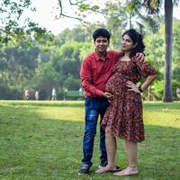 Indian couple posing for Maternity shoot pose for welcoming new born baby in Lodhi Garden in Delhi India, Maternity photo shoot done by parents for welcoming their child, Pre Baby Photo Shoot