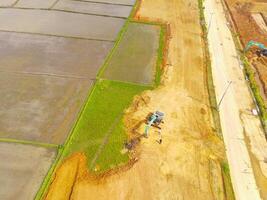 Heavy equipment vehicles are leveling the ground. Aerial drone view of Housing development on the edge of the city. View from above, Housing Industry. Above. Social issues. Shot from drone flying photo