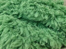 A green fluffy new carpet under your feet, in the hallway or bathroom. photo
