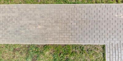 top view of the texture of paving slabs on pedestrian path photo