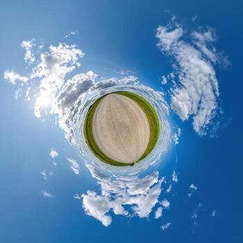simple tiny planet without buildings in blue sky with beautiful clouds. Transformation of spherical panorama 360 degrees. Spherical abstract aerial view. Curvature of space. photo