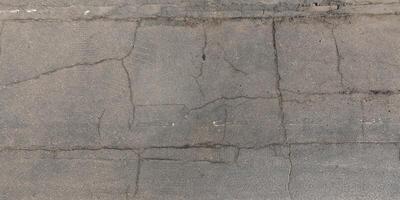 view from above on texture of asphalt road with cracks photo