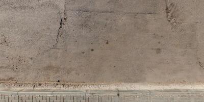 view from above on texture of asphalt road with cracks photo