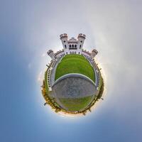 little planet and spherical aerial 360 panorama view on street ancient medieval castle with church and historic buildings with columns photo
