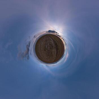 simple tiny planet without buildings in blue sky with beautiful clouds. Transformation of spherical panorama 360 degrees. Spherical abstract aerial view. Curvature of space. photo