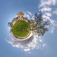 little planet and spherical aerial 360 panorama view on street ancient medieval castle with church and historic buildings with columns photo