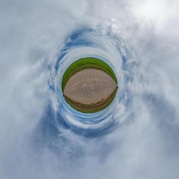 simple tiny planet without buildings in blue sky with beautiful clouds. Transformation of spherical panorama 360 degrees. Spherical abstract aerial view. Curvature of space. photo