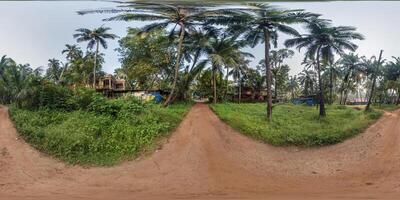 full seamless spherical hdr 360 panorama view among green street with cottages, villas and coconut trees in an indian tropic village in equirectangular projection, ready for VR AR virtual reality photo