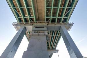 steel frame and concrete construction huge car bridge across the wide river photo