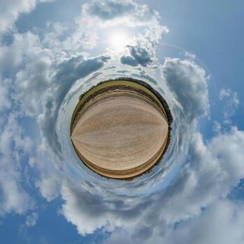 simple tiny planet without buildings in blue sky with beautiful clouds. Transformation of spherical panorama 360 degrees. Spherical abstract aerial view. Curvature of space. photo