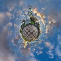 tallest hindu shiva statue in india on mountain near ocean on little planet in blue sky with evening clouds, transformation of spherical 360 panorama. Spherical abstract view with curvature of space. photo