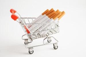 Cigarette in shopping cart, cost, trading, marketing and production, No smoking concept. photo