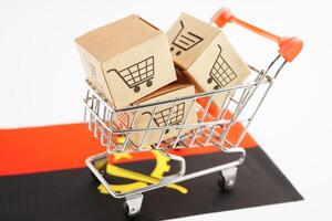 Online shopping, Shopping cart box on Angola flag, import export, finance commerce. photo