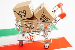 Online shopping, Shopping cart box on Iran flag, import export, finance commerce. photo
