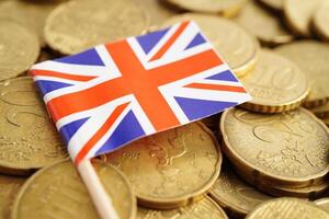 United Kingdom flag on coin and banknote money, finance trading investment business currency concept. photo