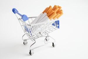 Cigarette in shopping cart, cost, trading, marketing and production, No smoking concept. photo