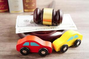 Car accident lawsuit and insurance, Judge hammer with car model. photo