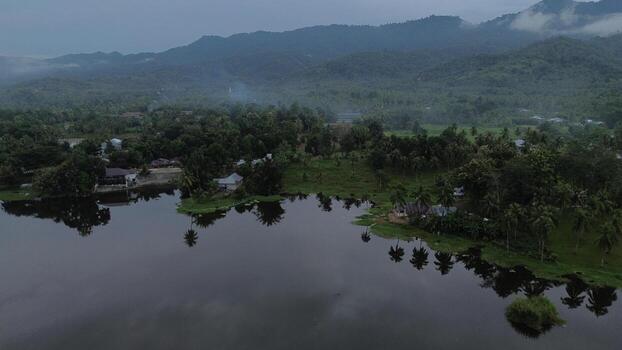 Aerial view of Perintis Lake surrounded by trees photo