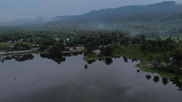 Aerial view of Perintis Lake surrounded by trees photo