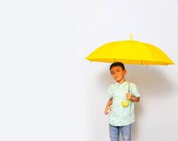 Cute little boy in casual outfit on background photo