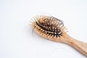 Hair loss fall with comb brush isolated on white background. photo