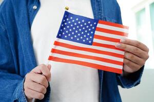 Learning English, Asian teenage student holding flag for language program education. photo