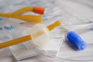 Foley catheter and urine drainage bag collect urine for disability or patient in hospital. photo