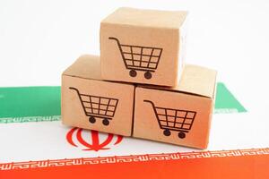 Online shopping, Shopping cart box on Iran flag, import export, finance commerce. photo