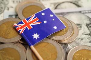 New Zealand flag on coins background, finance and accounting, banking concept. photo